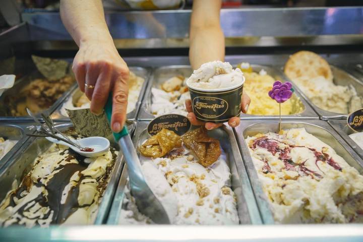 Heladero sirve una tarrina de helado